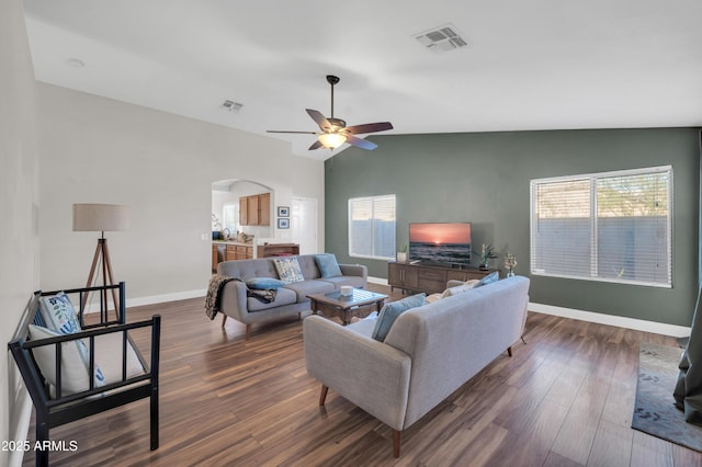 7405 W Elwood St, Phoenix, AZ 85043 - living room featuring arched walkways, a ceiling fan, baseboards, dark wood-type flooring, and vaulted ceiling