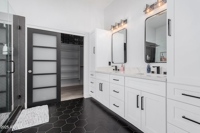 bathroom featuring vanity, tile patterned floors, and a shower with shower door