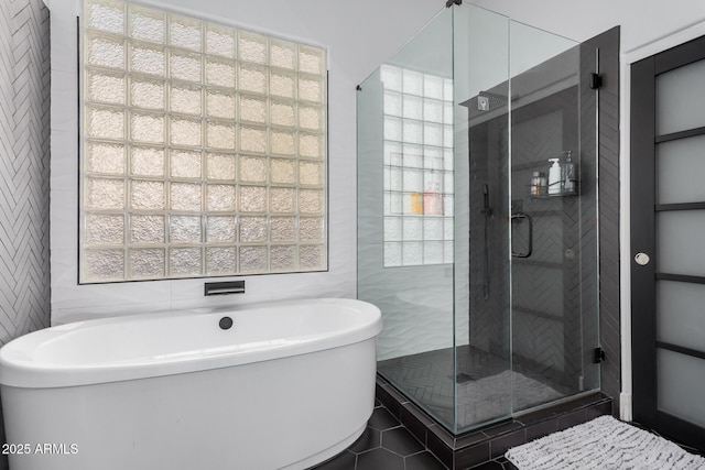 bathroom featuring tile walls and plus walk in shower