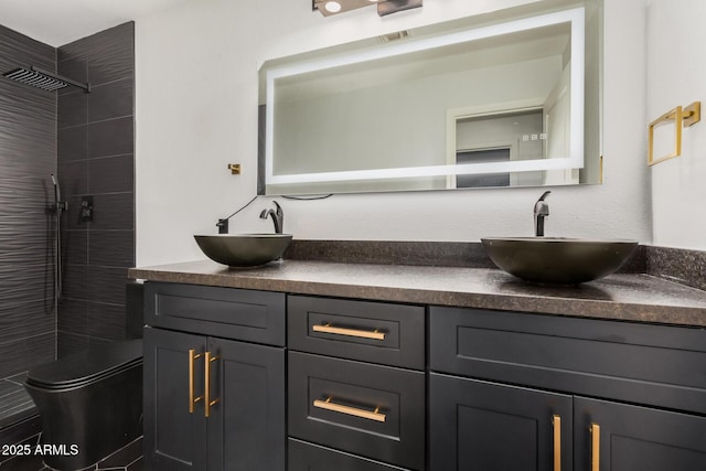 bathroom featuring vanity, toilet, and a tile shower