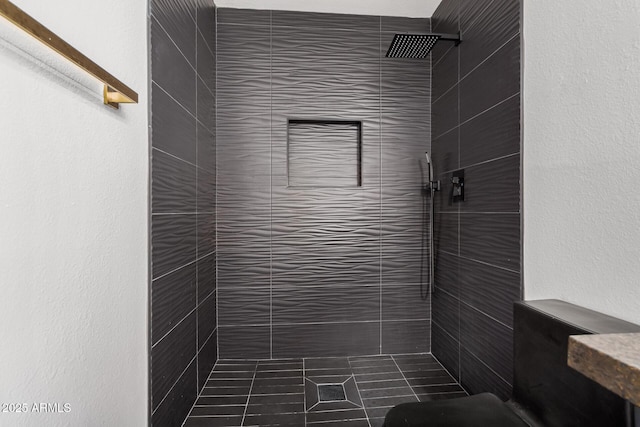 bathroom with tiled shower