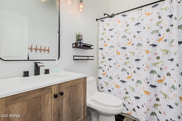 bathroom featuring vanity, toilet, and walk in shower