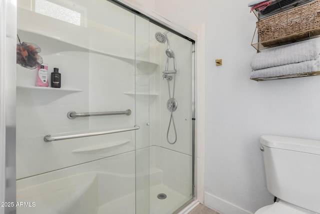 bathroom featuring toilet and walk in shower