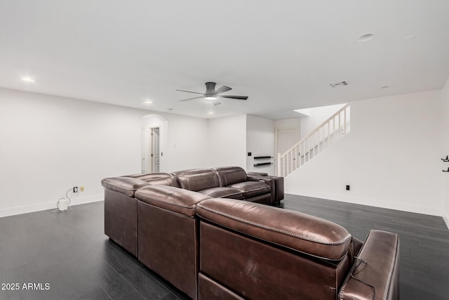 living room with dark wood-type flooring and ceiling fan