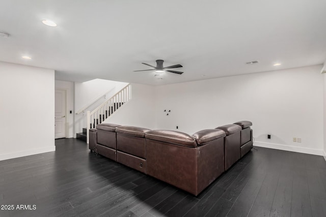 living room with ceiling fan and dark hardwood / wood-style flooring