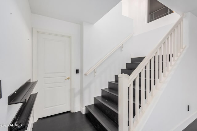 staircase with hardwood / wood-style flooring