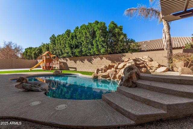 view of swimming pool featuring a playground