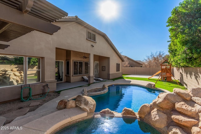 view of pool with ceiling fan, a patio area, and a playground