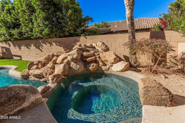 view of pool with a jacuzzi