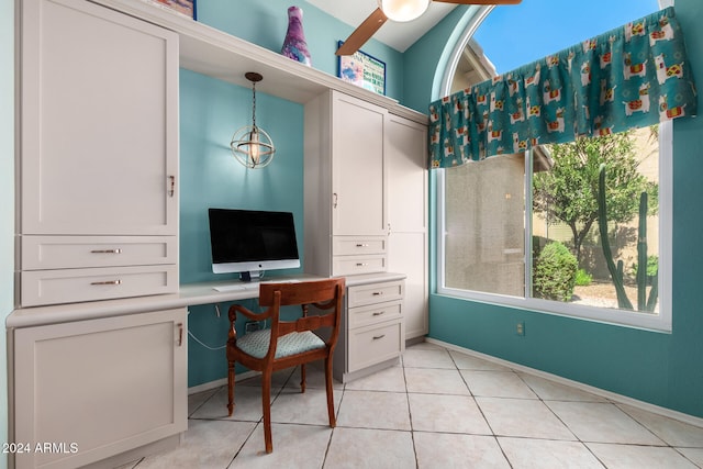 tiled home office featuring built in desk and ceiling fan