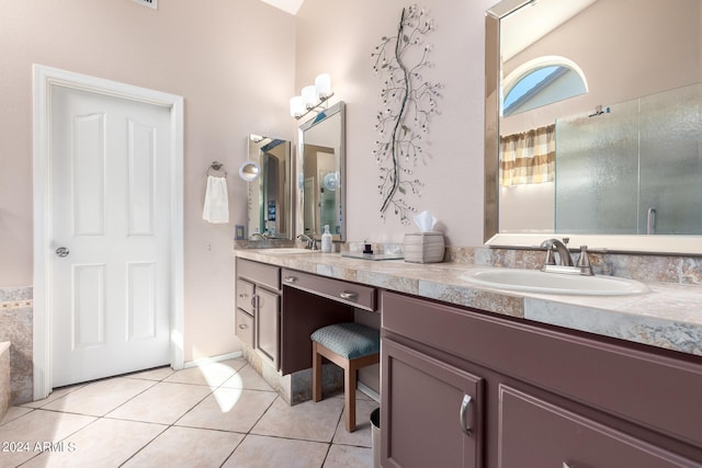 bathroom featuring walk in shower, vanity, and tile patterned flooring