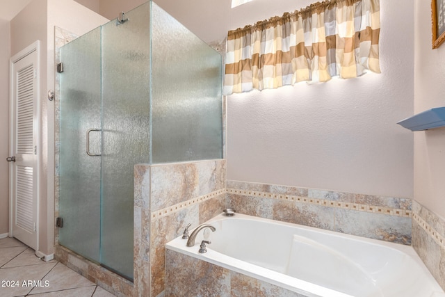 bathroom with shower with separate bathtub and tile patterned floors