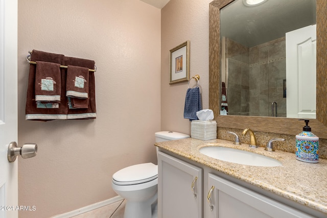 bathroom with vanity, toilet, tile patterned floors, and a shower with door