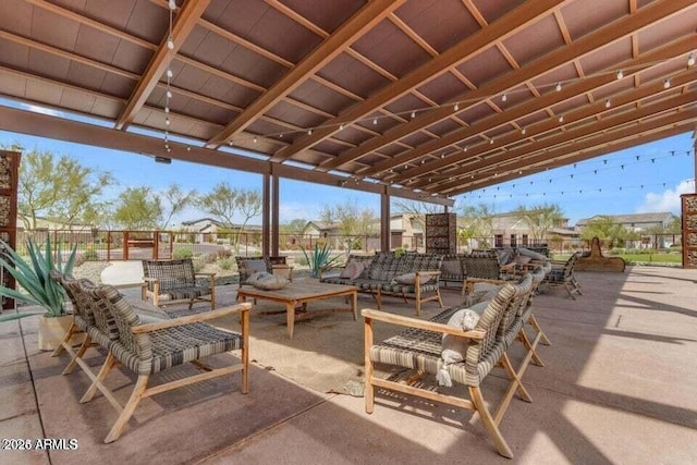 view of patio with a residential view, fence, and an outdoor living space