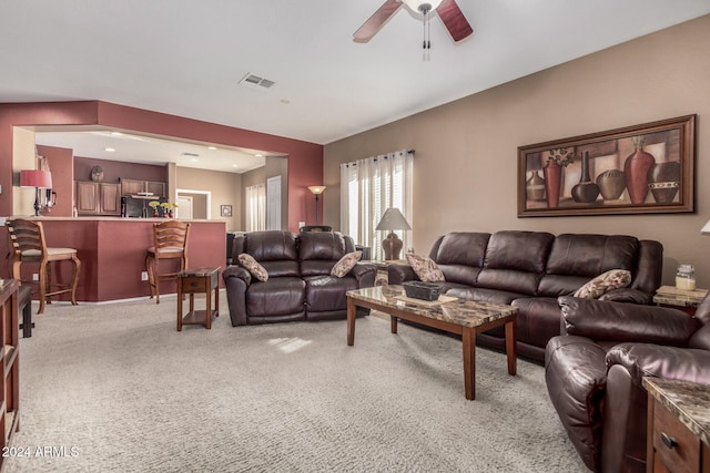 living room featuring light carpet and ceiling fan