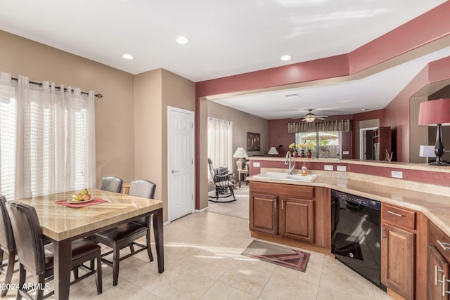 kitchen featuring ceiling fan, light tile patterned floors, sink, and black dishwasher