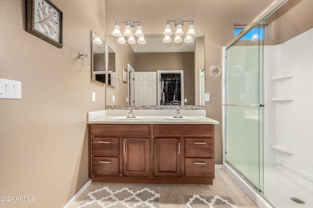 bathroom featuring vanity, a shower with door, and tile patterned floors