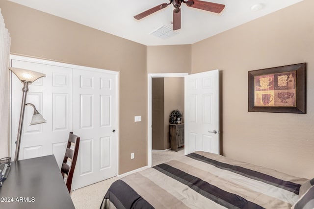 carpeted bedroom featuring a closet and ceiling fan