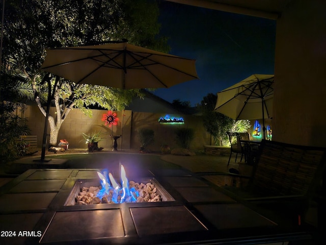 pool at twilight featuring a fire pit