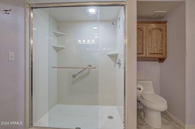 bathroom with baseboards, visible vents, a shower stall, and toilet