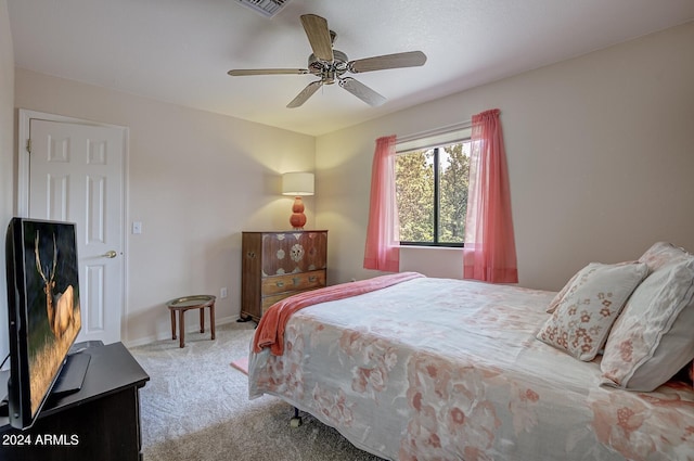 bedroom featuring ceiling fan, baseboards, and light colored carpet