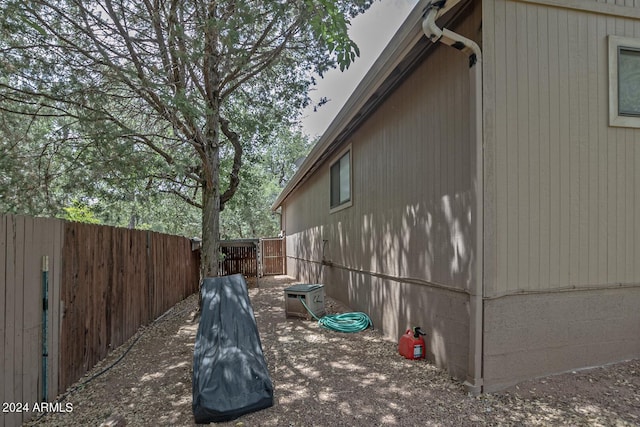 view of side of home with a fenced backyard