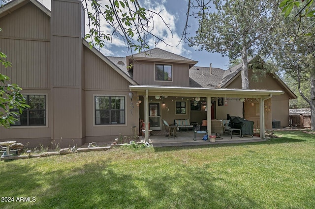 back of house with an outdoor hangout area, a yard, and a patio area