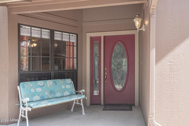 entrance to property featuring stucco siding