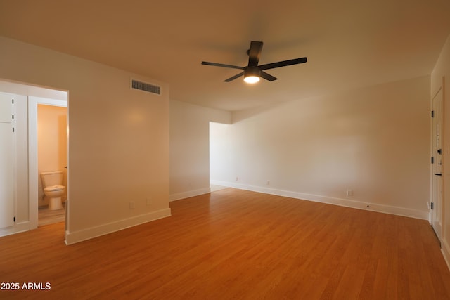 unfurnished room featuring ceiling fan, baseboards, and light wood-type flooring