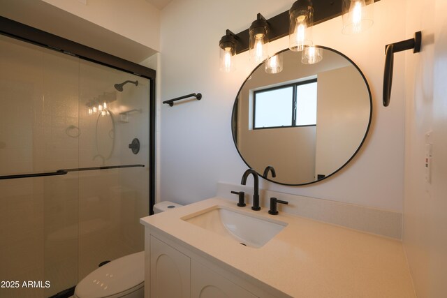 full bath featuring toilet, a shower stall, and vanity