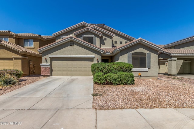 23848 W Grove St, Buckeye, AZ 85326 - view of front of home with concrete driveway, stucco siding, a tiled roof, and a garage