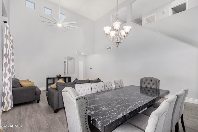 23848 W Grove St, Buckeye, AZ 85326 - dining space featuring baseboards, a chandelier, visible vents, high vaulted ceiling, and wood finished floors