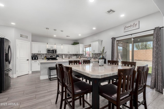 23848 W Grove St, Buckeye, AZ 85326 - dining room with light wood-style flooring, visible vents, and recessed lighting