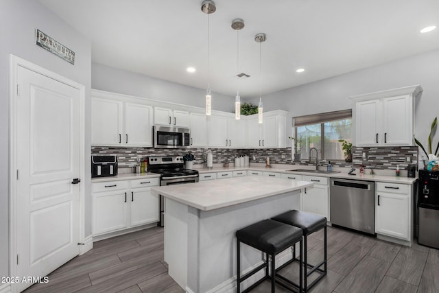 23848 W Grove St, Buckeye, AZ 85326 - kitchen with backsplash, a sink, white cabinetry, and stainless steel appliances