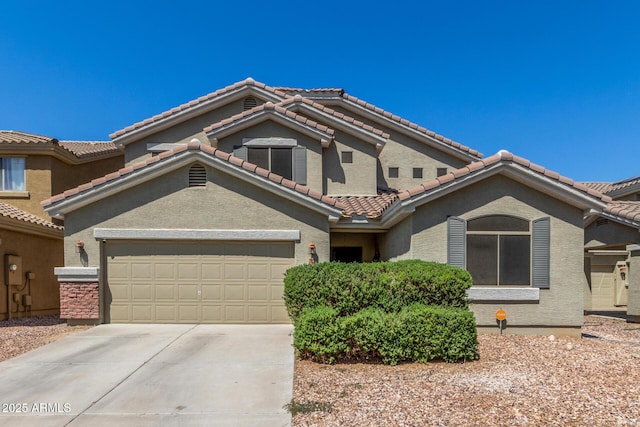 23848 W Grove St, Buckeye, AZ 85326 - mediterranean / spanish-style home featuring an attached garage, driveway, stucco siding, and a tile roof