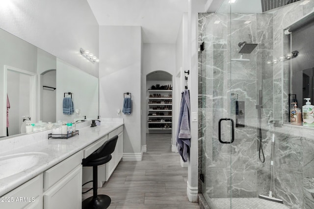 23848 W Grove St, Buckeye, AZ 85326 - full bathroom with double vanity, a sink, and a marble finish shower