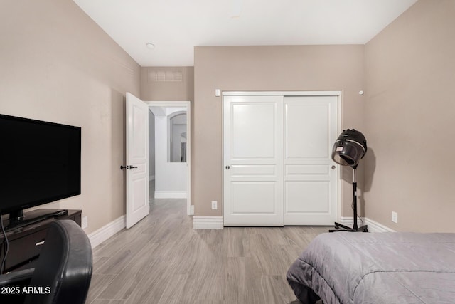 23848 W Grove St, Buckeye, AZ 85326 - bedroom featuring a closet, light wood finished floors, and baseboards