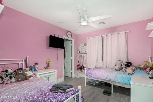 23848 W Grove St, Buckeye, AZ 85326 - bedroom with wood finished floors, ceiling fan, baseboards, and visible vents