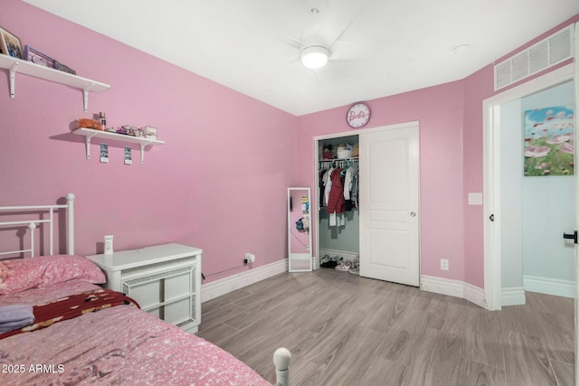 23848 W Grove St, Buckeye, AZ 85326 - bedroom with a closet, baseboards, a ceiling fan, light wood-style floors, and visible vents