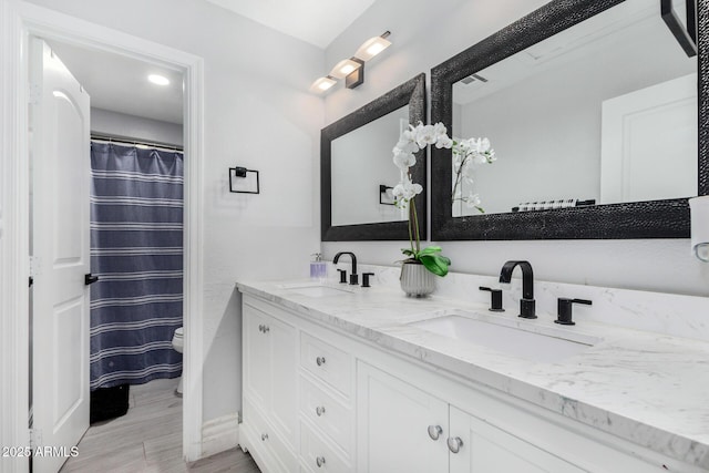 23848 W Grove St, Buckeye, AZ 85326 - full bathroom featuring toilet, double vanity, a sink, and visible vents