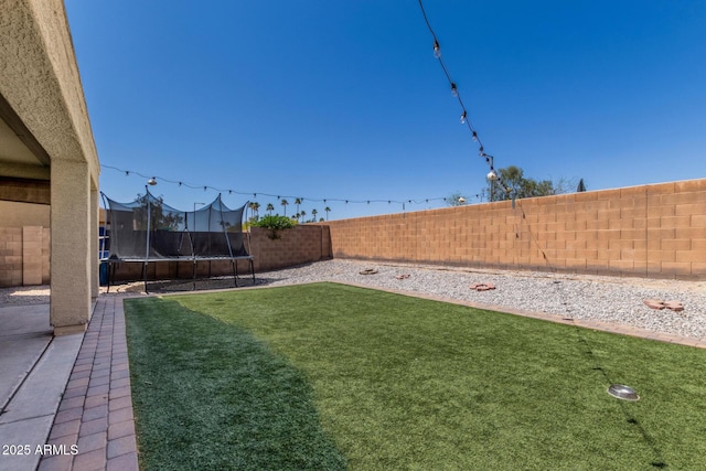 23848 W Grove St, Buckeye, AZ 85326 - view of yard featuring a trampoline and a fenced backyard