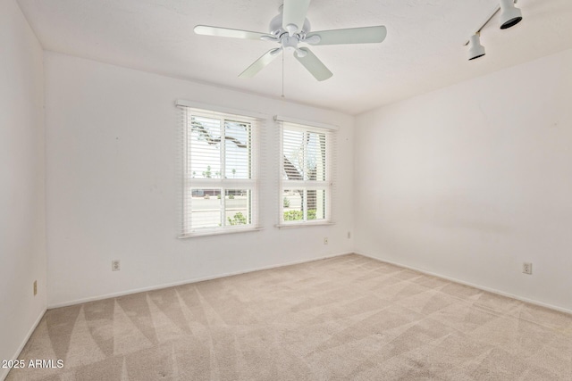 8328 E Chaparral Rd, Scottsdale, AZ 85250 - unfurnished room with healthy amount of natural light, light colored carpet, ceiling fan, and track lighting