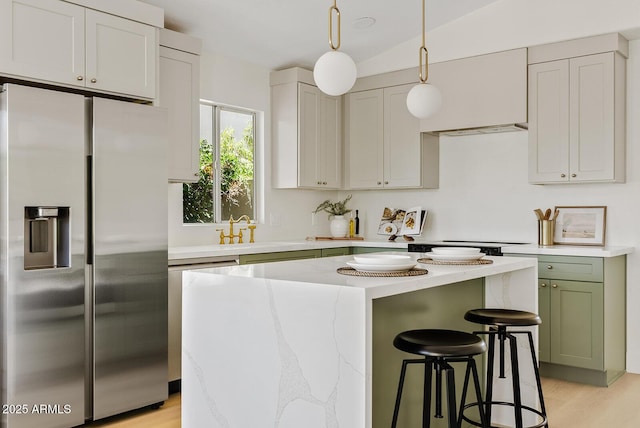 732 W Sagebrush St, Gilbert, AZ 85233 - kitchen featuring stainless steel refrigerator with ice dispenser, light wood-style floors, a kitchen breakfast bar, pendant lighting, and a kitchen island