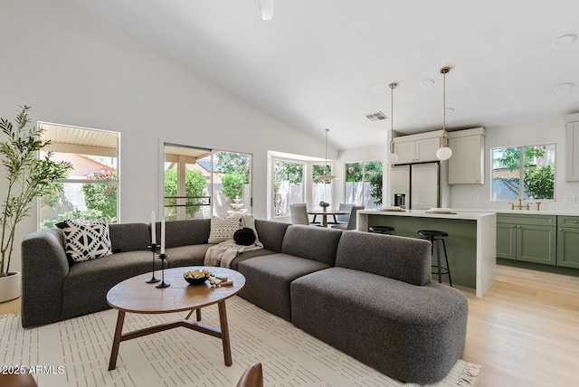 732 W Sagebrush St, Gilbert, AZ 85233 - living room featuring light wood-style floors, plenty of natural light, and high vaulted ceiling