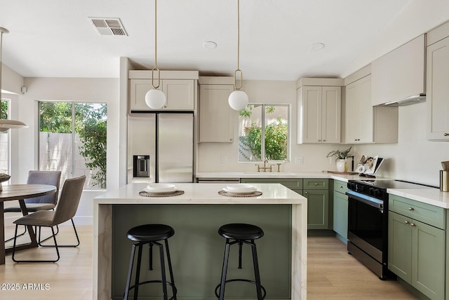 732 W Sagebrush St, Gilbert, AZ 85233 - kitchen featuring stainless steel refrigerator with ice dispenser, range with electric stovetop, green cabinets, and a sink