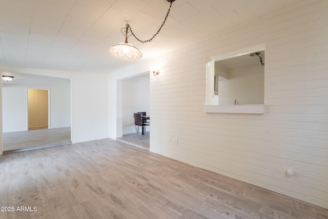 1124 S Longwood Loop, Mesa, AZ 85208 - unfurnished room with wood finished floors and brick wall