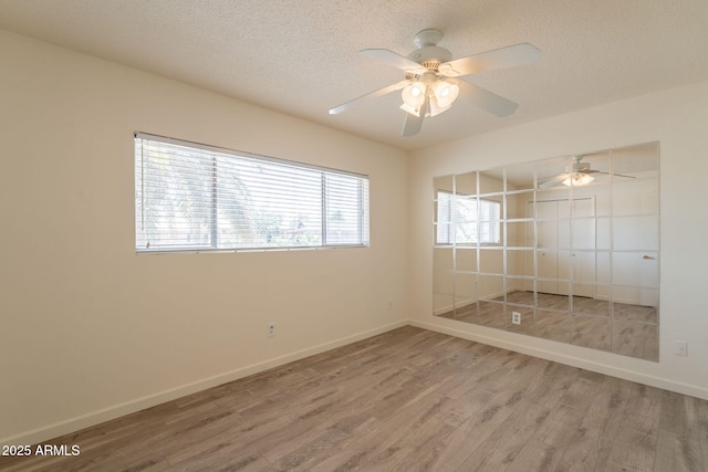 1124 S Longwood Loop, Mesa, AZ 85208 - empty room featuring light wood-type flooring, ceiling fan, and a textured ceiling