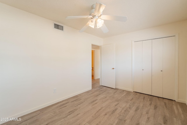 1124 S Longwood Loop, Mesa, AZ 85208 - unfurnished bedroom featuring light wood-style flooring, a closet, and a ceiling fan