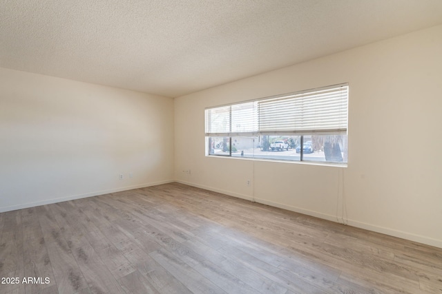 1124 S Longwood Loop, Mesa, AZ 85208 - empty room with light wood-style floors and a textured ceiling