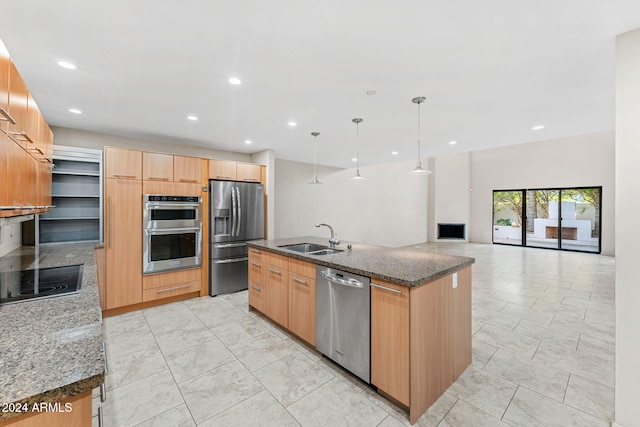 7385 E Pleasant Run, Scottsdale, AZ 85258 - kitchen with stainless steel appliances, an island with sink, dark stone countertops, recessed lighting, and decorative light fixtures